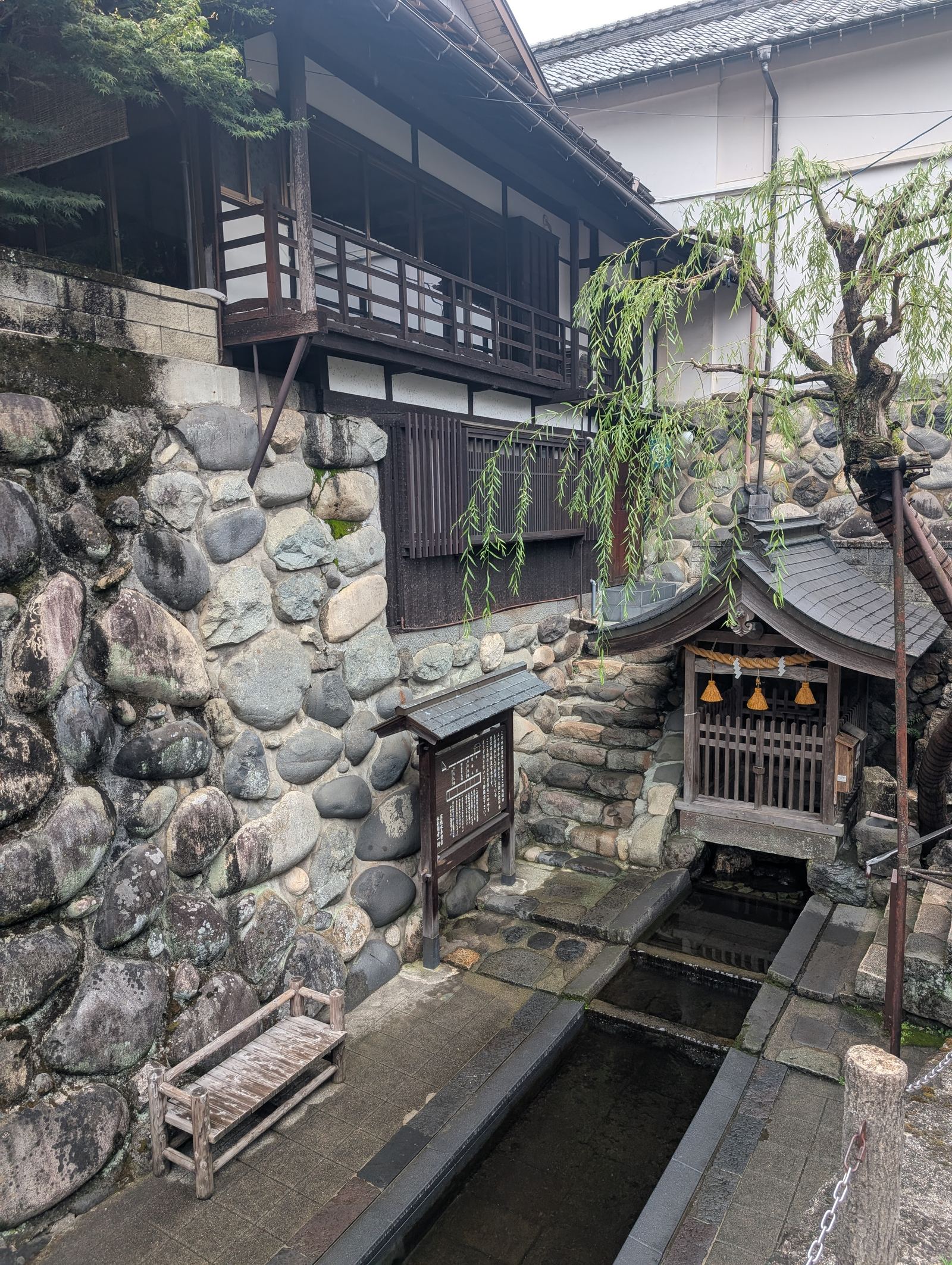 A stone water fountain fed by Gujo Hachiman's famously clear spring water
