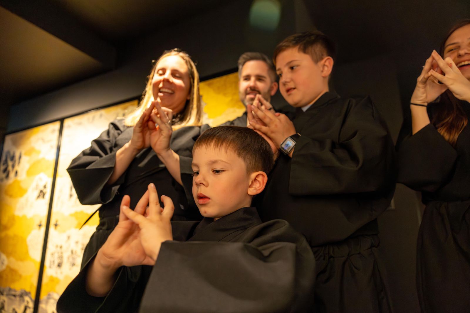 Kids in ninja costumes listening intently