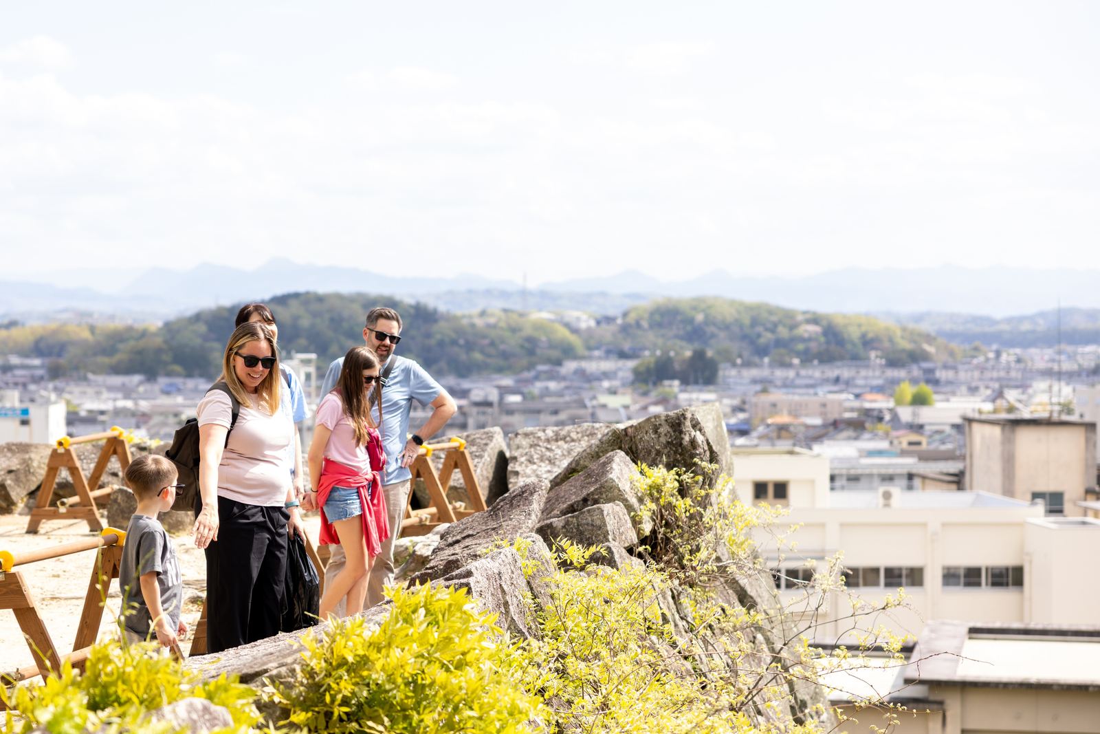 Family exploring the castle ruins with city views