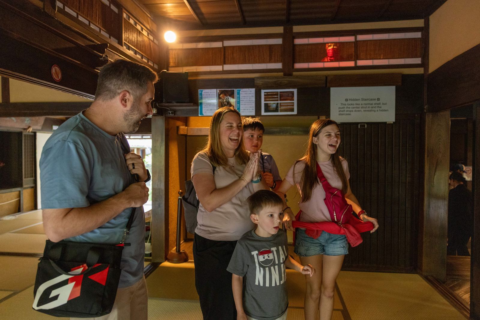 Family laughing at the hidden staircase in the ninja house