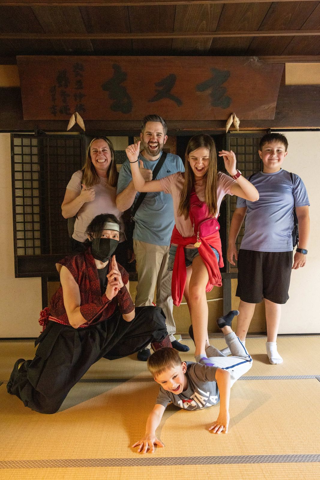 Family posing and laughing with the ninja performer