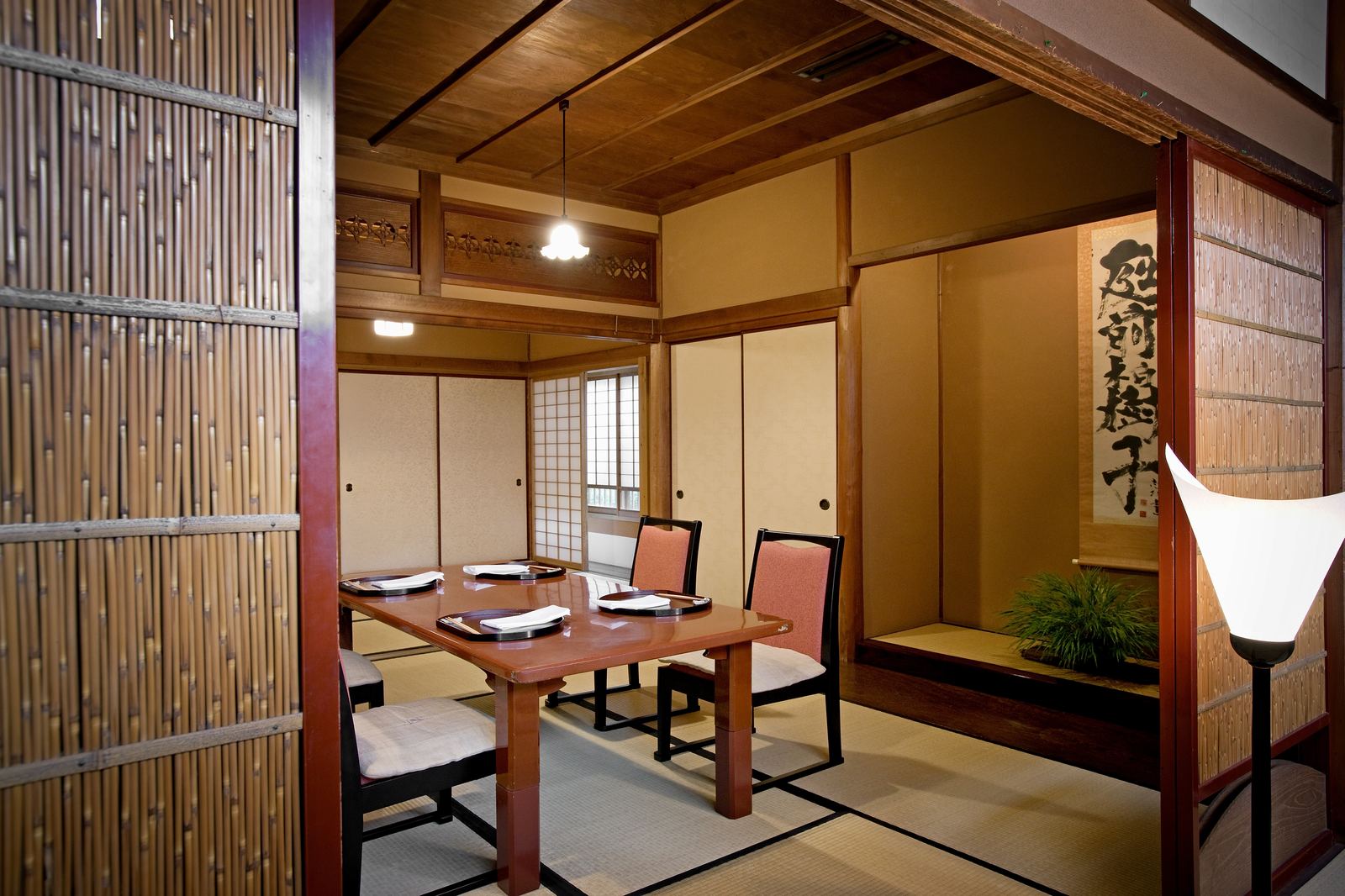 A tatami dining room at Shiratama, seen through a bamboo screen
