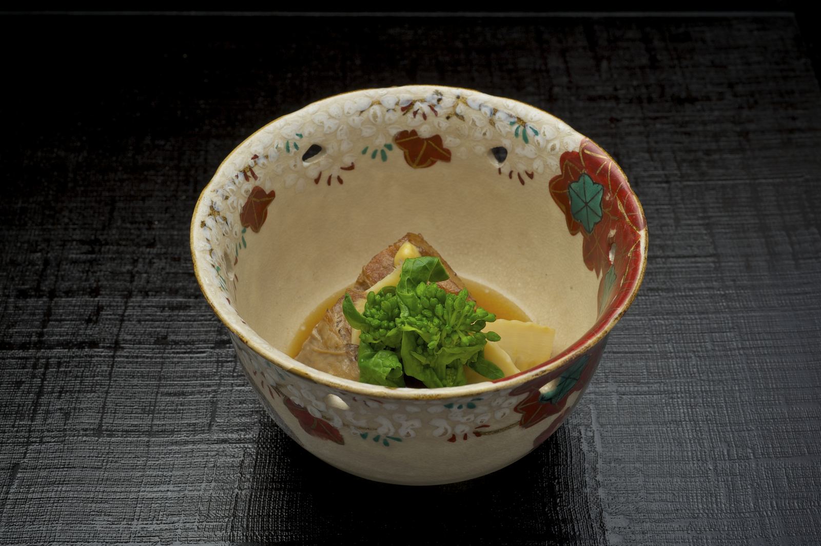 A simmered dish served in a decorative ceramic bowl
