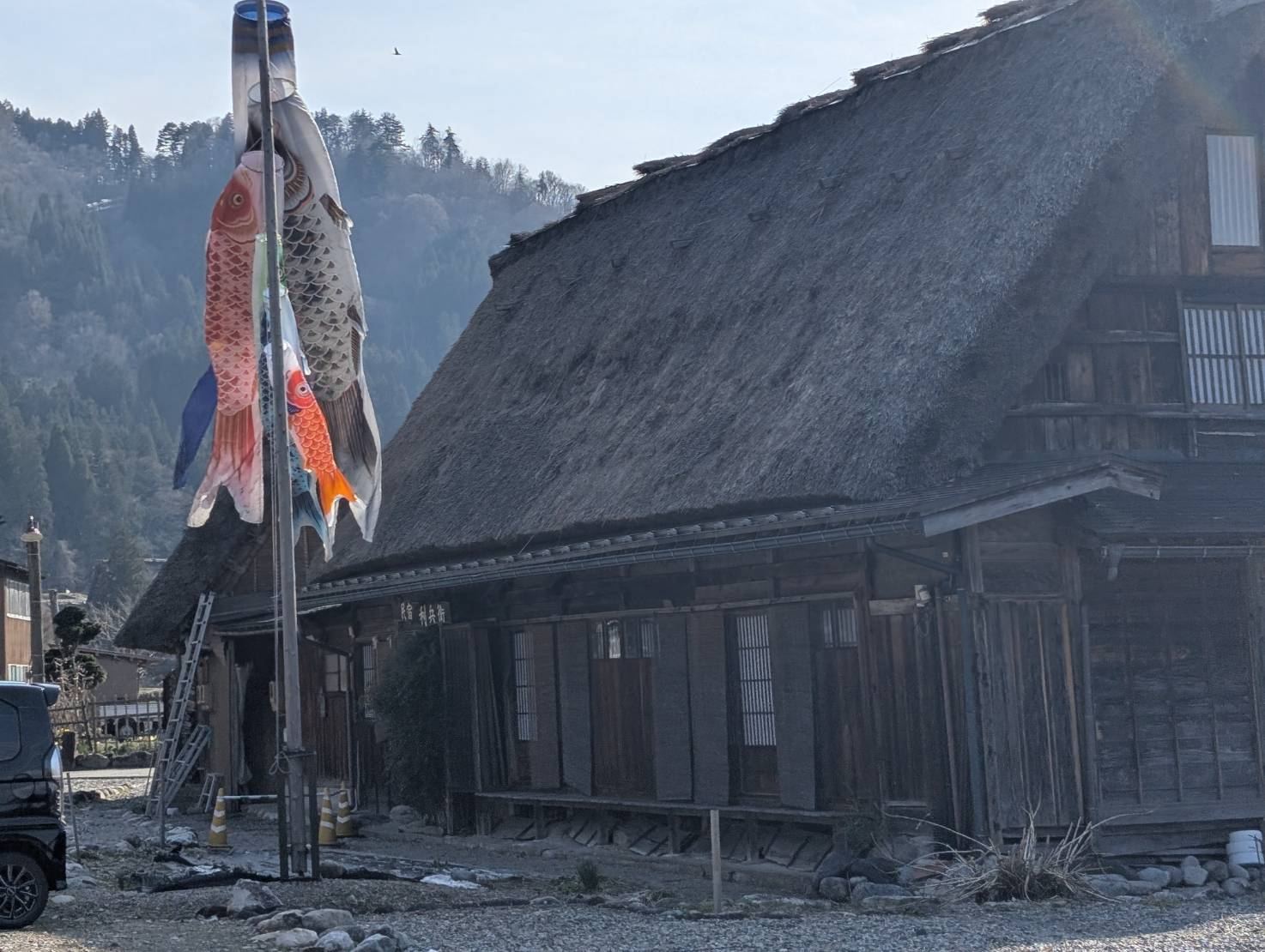 Koinobori carp streamers at a thatched farmhouse