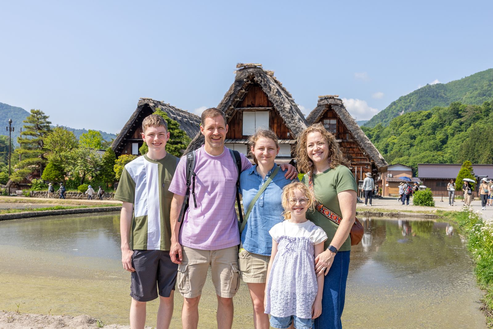 Family photo in front of gassho-zukuri farmhouses at Shirakawa-go