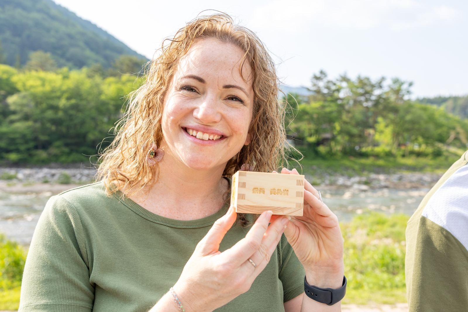 Close-up of a wooden engraved keepsake box held up to camera